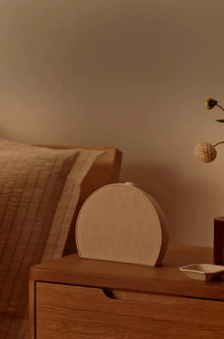 Hatch Restore 3 in Putty colourway on a wooden bedside table